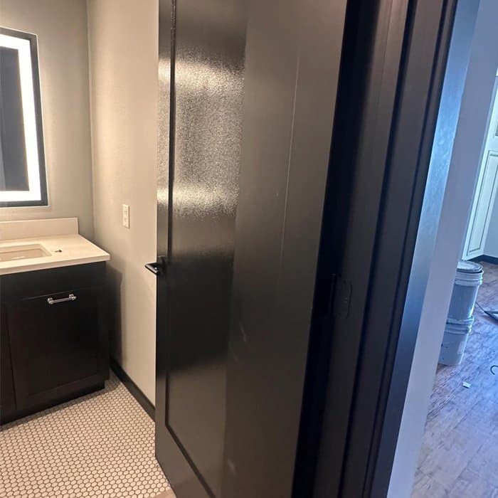Finished bathroom with fresh paint and a newly installed black door